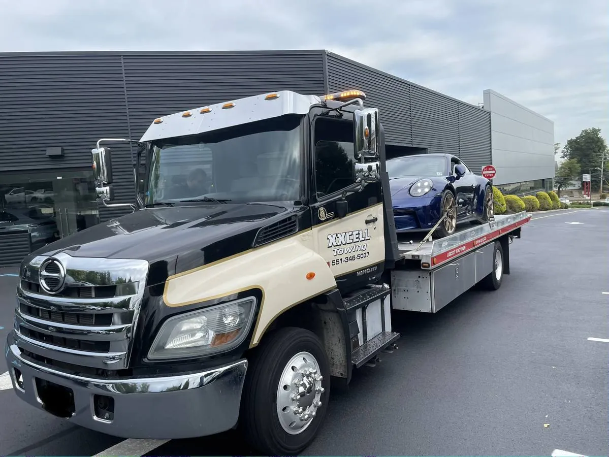 XXCELL Towing flatbed truck loading a Porsche 911 in Bergen County NJ