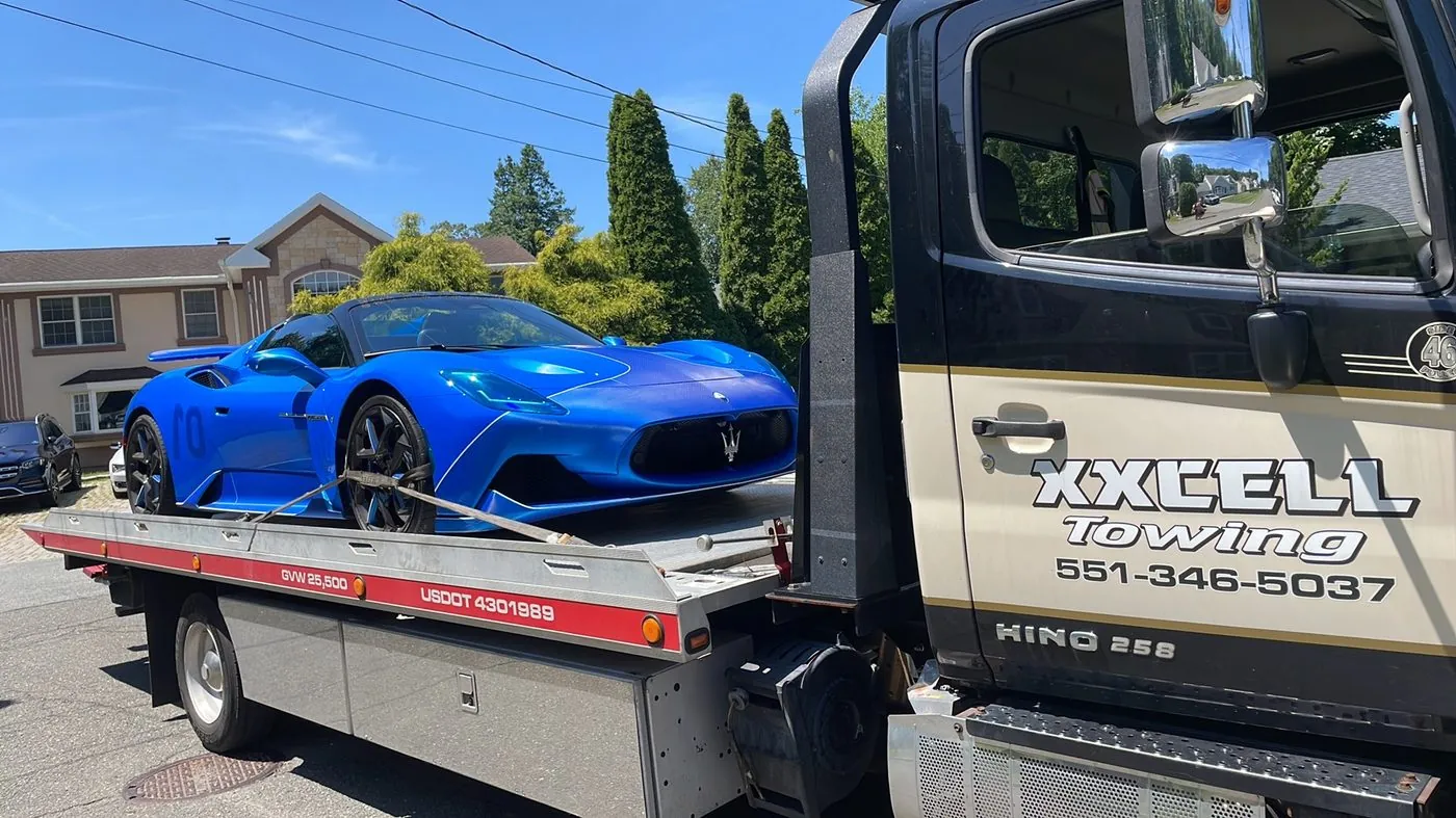 XXCELL Towing flatbed with a blue Maserati MC20 in Bergen County NJ