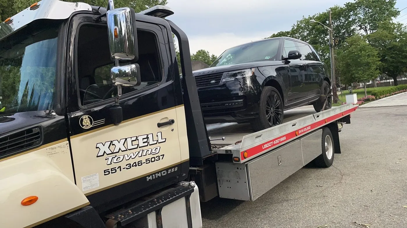 XXCELL Towing flatbed with a Range Rover in Bergen County NJ
