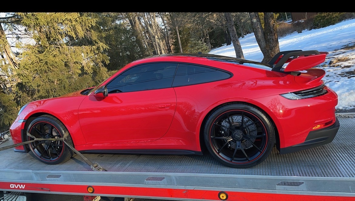 XXCELL Towing transporting red Porsche sports car on flatbed in Bergen County NJ