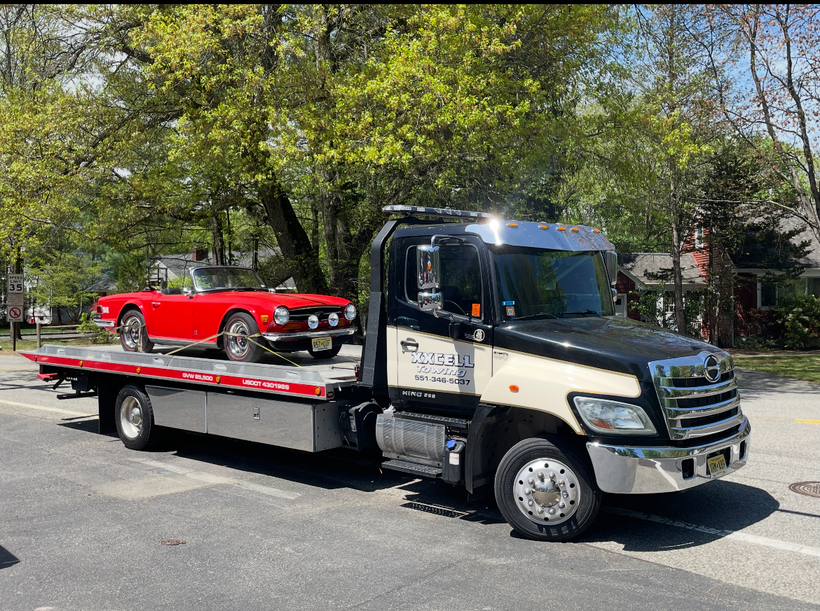 XXCELL Towing flatbed truck transporting classic car in Bergen County NJ