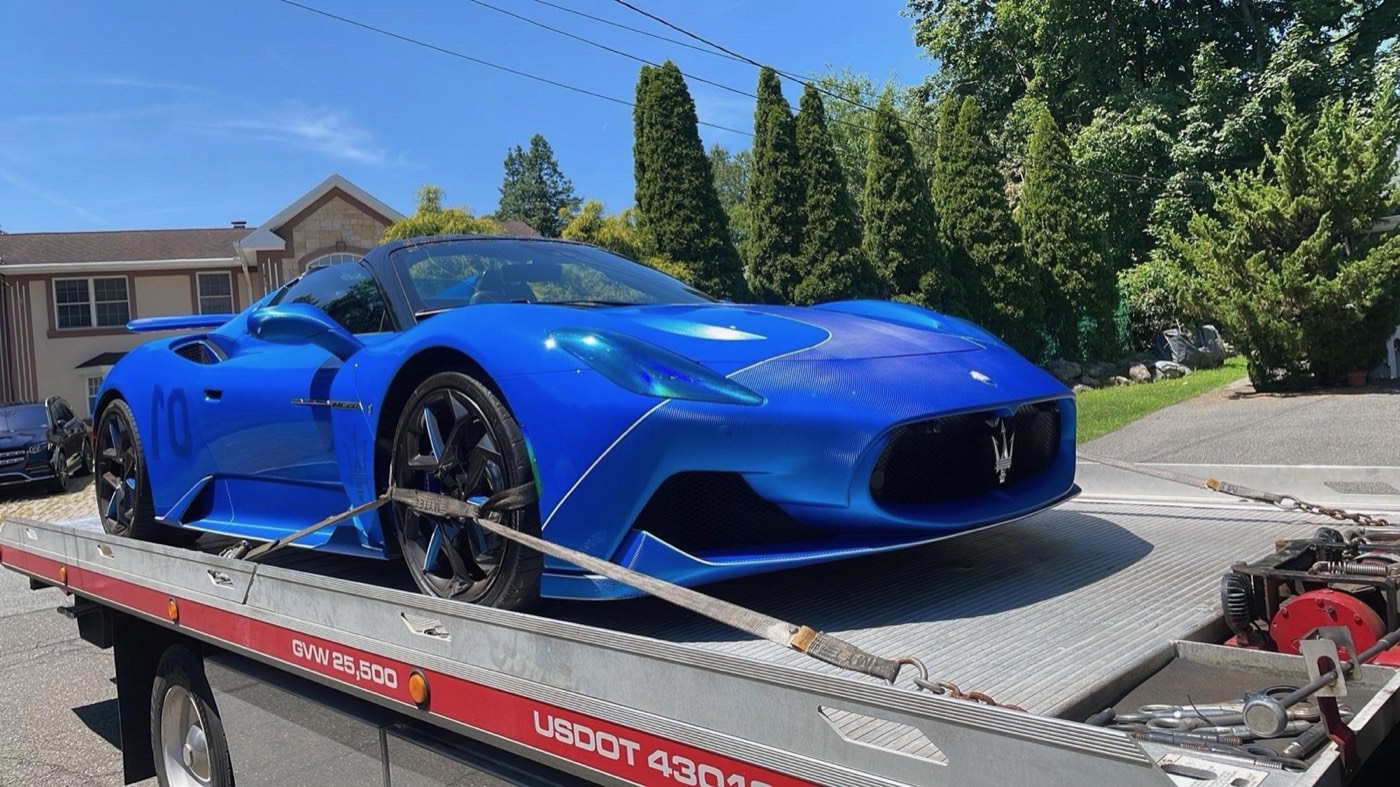 Maserati transported by XXCELL Towing on a flatbed